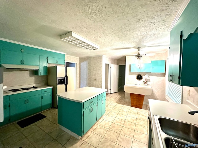 kitchen with white appliances, a textured ceiling, green cabinetry, sink, and ceiling fan