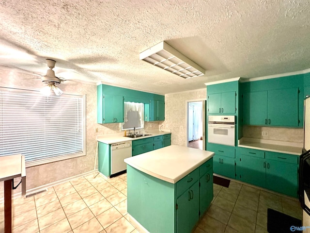 kitchen featuring white appliances, sink, green cabinetry, and ceiling fan