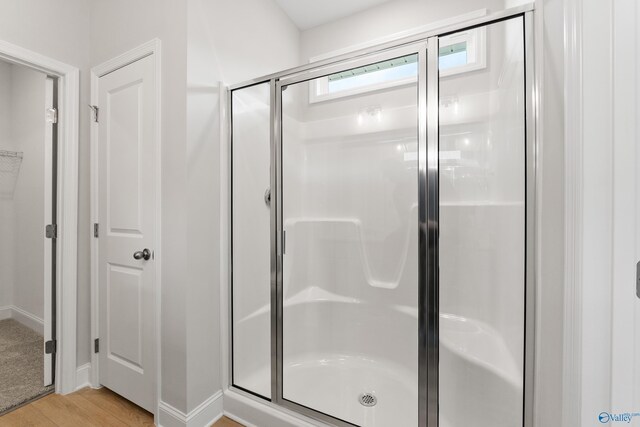 162 River Pointe Dr, New Market, AL 35761 - bathroom with baseboards, wood finished floors, and a stall shower