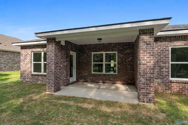 162 River Pointe Dr, New Market, AL 35761 - back of property with a yard, a patio, and brick siding