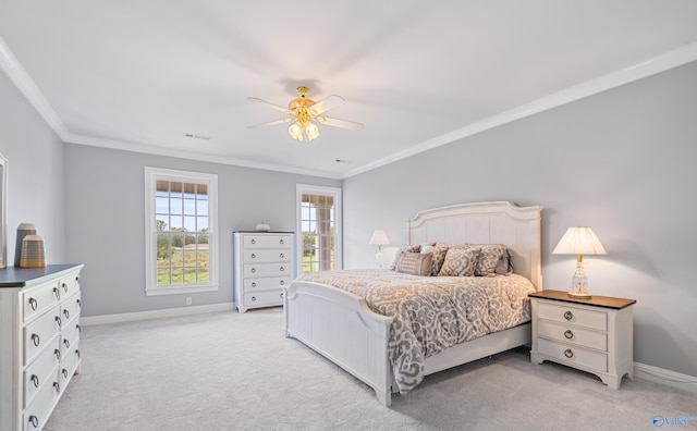 bedroom featuring ornamental molding, light colored carpet, baseboards, and a ceiling fan