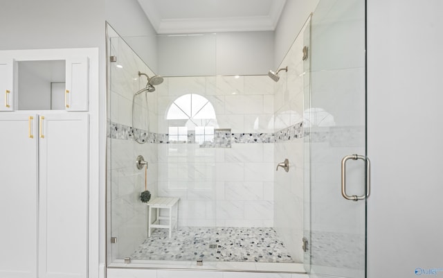 full bathroom featuring ornamental molding and a shower stall