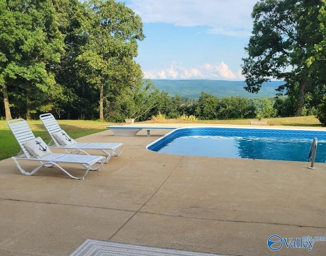 pool featuring a patio and a diving board