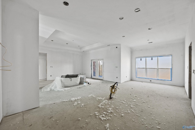 unfurnished living room with a raised ceiling