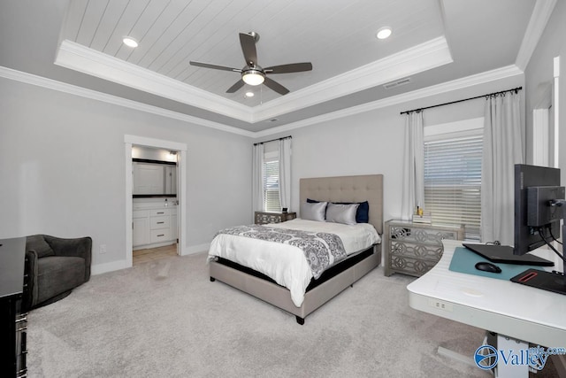 bedroom featuring ceiling fan, a tray ceiling, and light carpet