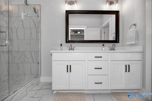 bathroom featuring a shower with door and vanity