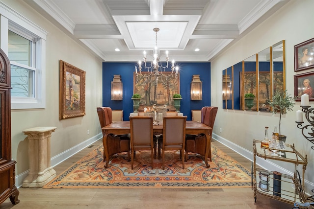 dining area with hardwood / wood-style flooring, ornamental molding, beamed ceiling, an inviting chandelier, and coffered ceiling