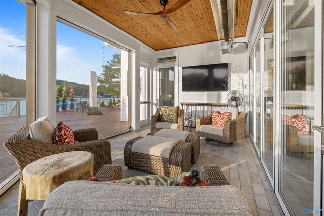 sunroom with wooden ceiling and ceiling fan