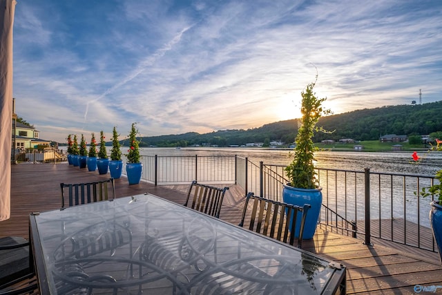 deck at dusk featuring a mountain view