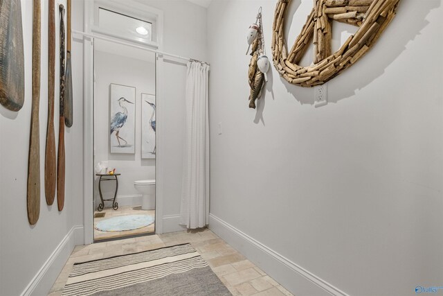 corridor featuring light tile patterned flooring