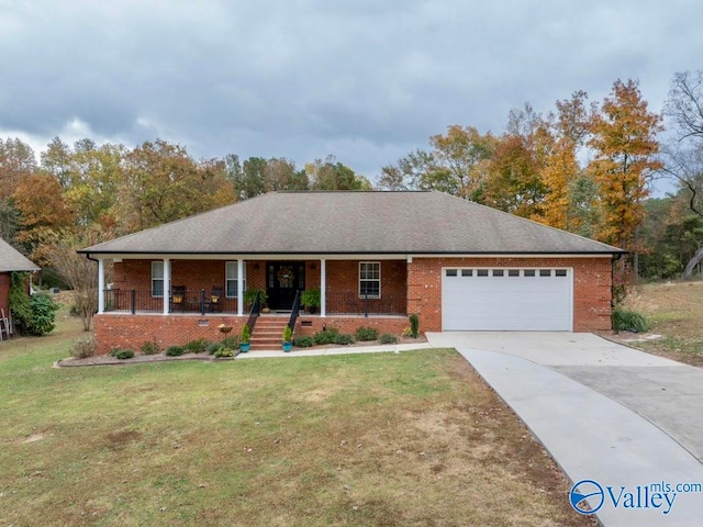 single story home featuring covered porch, a garage, and a front yard