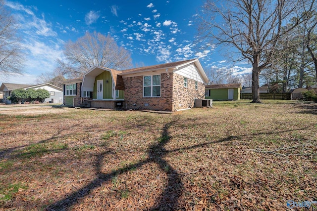 view of front of house featuring central AC unit and a front lawn