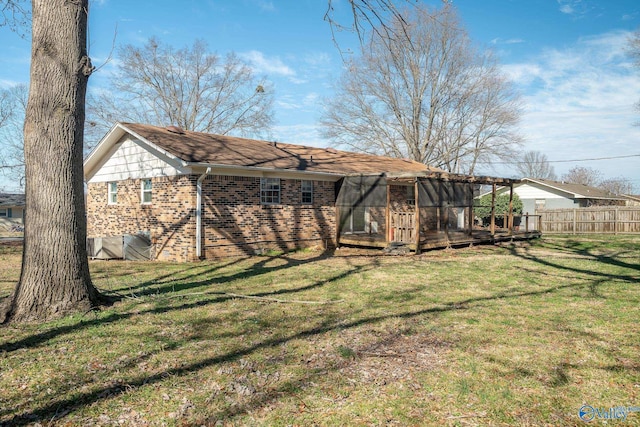 rear view of property with a lawn