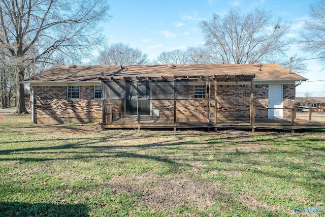 back of house featuring a lawn and a wooden deck