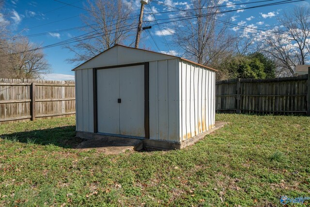 view of outbuilding featuring a lawn