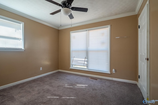 empty room with ceiling fan, carpet floors, and ornamental molding