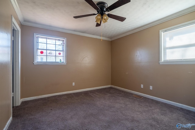 unfurnished room with dark carpet, crown molding, and a wealth of natural light