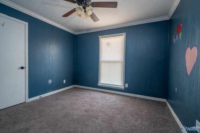 carpeted spare room featuring ceiling fan and crown molding