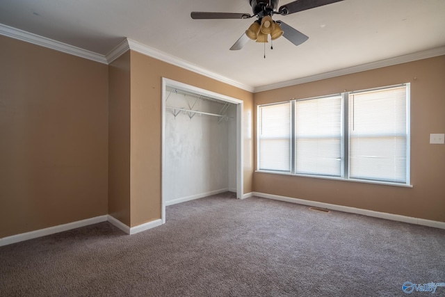 unfurnished bedroom featuring a closet, ceiling fan, carpet floors, and ornamental molding