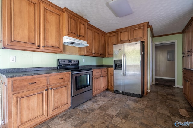 kitchen with appliances with stainless steel finishes, a textured ceiling, and ornamental molding