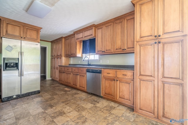 kitchen featuring appliances with stainless steel finishes, ornamental molding, and sink