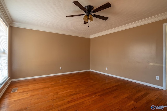 empty room with crown molding, ceiling fan, and wood-type flooring