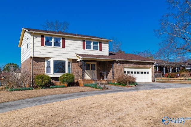 traditional-style home with a garage, concrete driveway, and brick siding