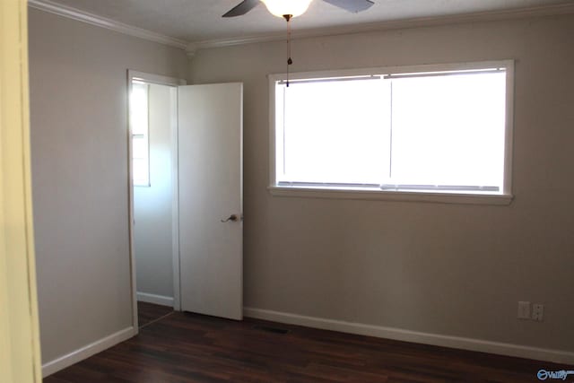 unfurnished bedroom featuring dark hardwood / wood-style flooring, multiple windows, ceiling fan, and ornamental molding