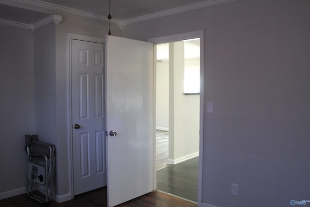 unfurnished bedroom featuring ornamental molding and dark hardwood / wood-style floors