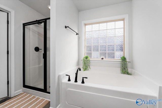 bathroom featuring separate shower and tub