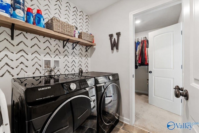 clothes washing area with separate washer and dryer and carpet floors