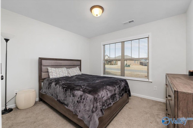 bedroom featuring light carpet