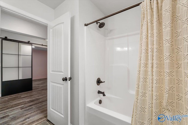 bathroom featuring wood-type flooring and shower / bath combo with shower curtain