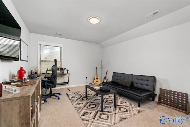 carpeted office featuring vaulted ceiling