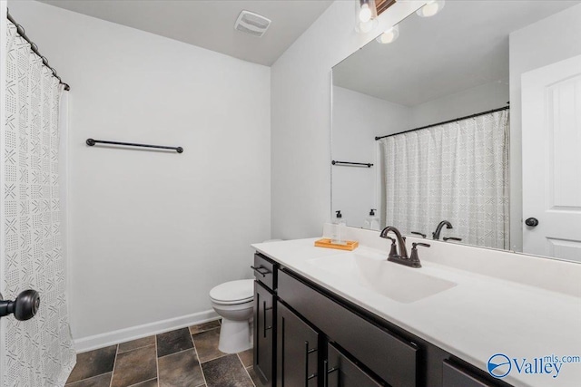 bathroom featuring toilet and vanity