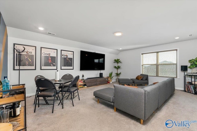 living room with light carpet and vaulted ceiling