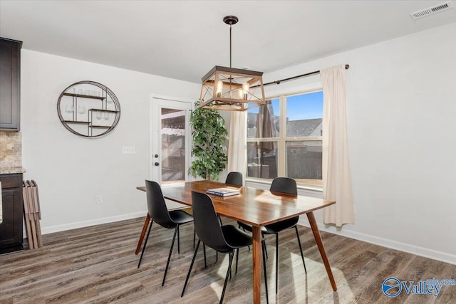 dining space with dark hardwood / wood-style flooring