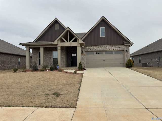 craftsman-style house featuring board and batten siding, brick siding, and driveway