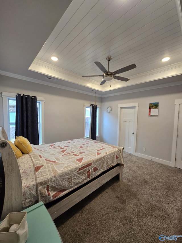 bedroom featuring carpet, baseboards, visible vents, crown molding, and a raised ceiling