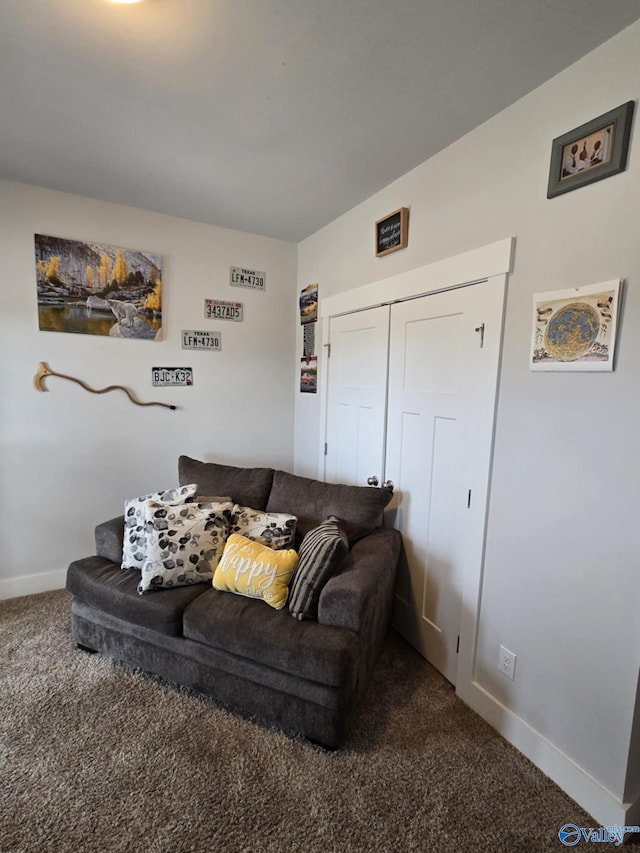 carpeted living area with baseboards