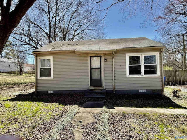 view of front of property with crawl space, fence, and entry steps