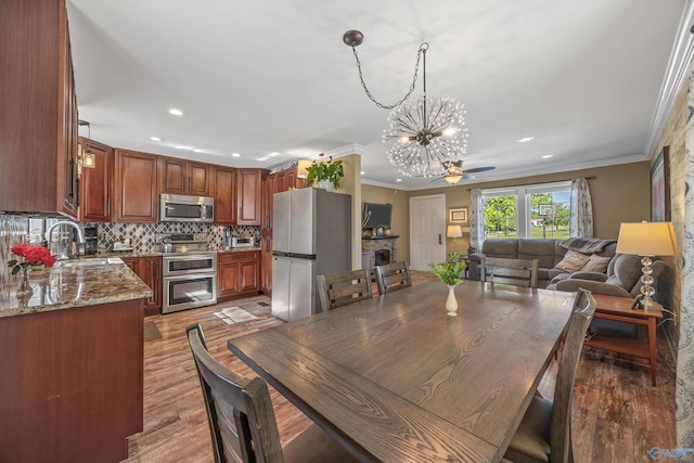 199 Ford Chapel Dr, Harvest, AL 35749 - dining room with a chandelier, light wood finished floors, crown molding, recessed lighting, and ceiling fan