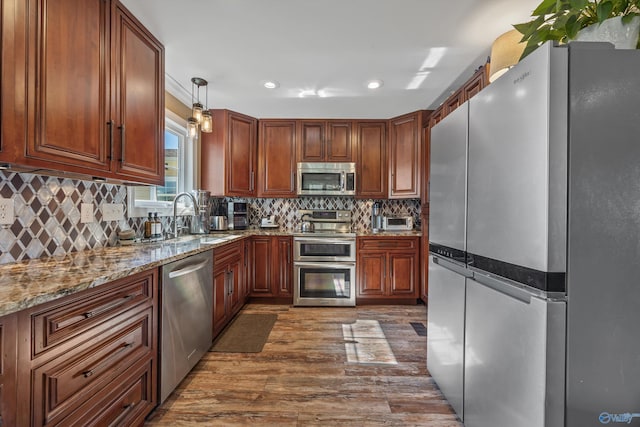 199 Ford Chapel Dr, Harvest, AL 35749 - kitchen featuring stainless steel appliances, a sink, dark wood finished floors, light stone countertops, and recessed lighting