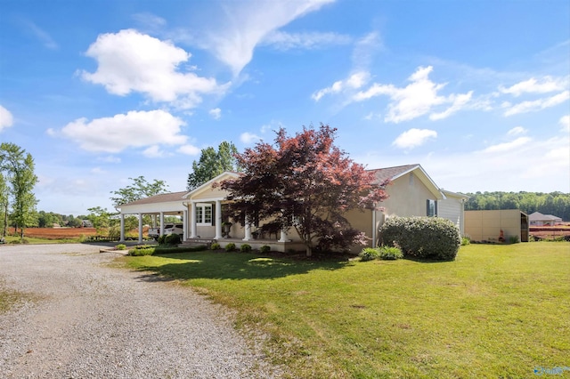 199 Ford Chapel Dr, Harvest, AL 35749 - view of front of house with driveway, a front lawn, stucco siding, and a carport