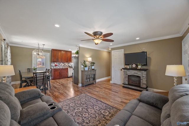 199 Ford Chapel Dr, Harvest, AL 35749 - living area with baseboards, ceiling fan, wood finished floors, ornamental molding, and a stone fireplace