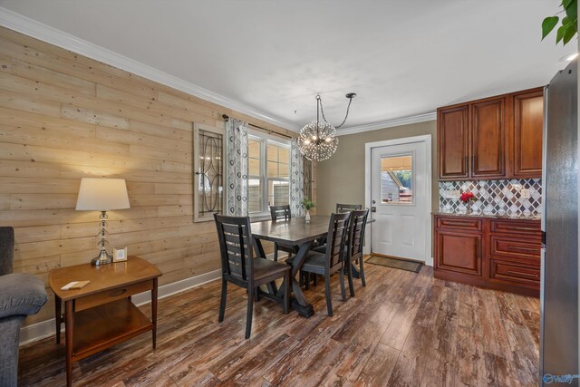 199 Ford Chapel Dr, Harvest, AL 35749 - dining space with a chandelier, ornamental molding, dark wood-style floors, baseboards, and wood walls