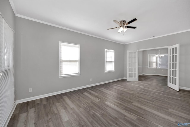 spare room with dark hardwood / wood-style flooring, ceiling fan with notable chandelier, and ornamental molding