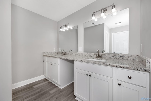 bathroom featuring vanity and hardwood / wood-style flooring