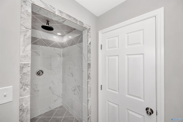 bathroom featuring a tile shower and tile patterned floors