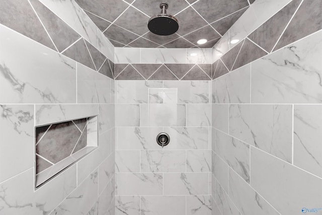 bathroom with tiled shower